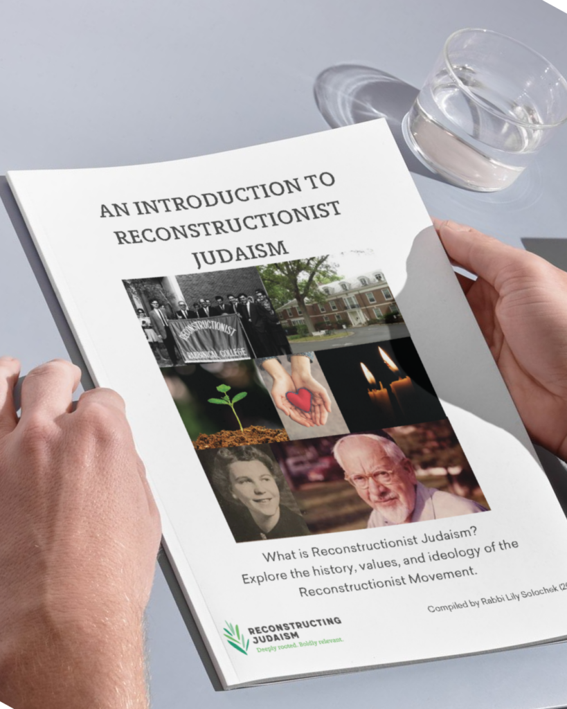Person holding a booklet titled An Introduction to Reconstructionist Judaism with various images on the cover.