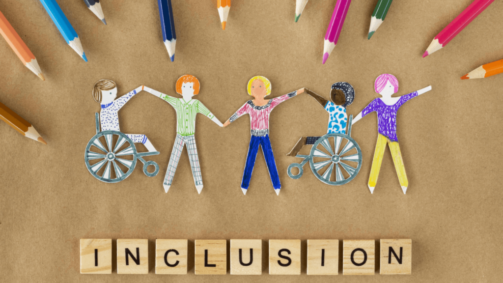 Paper cutouts of diverse children holding hands, surrounded by colored pencils, with Inclusion in block letters below.