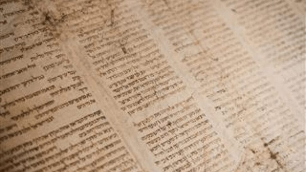 Ancient Hebrew text written on aged, yellowed parchment with visible creases and worn edges.